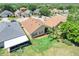 Aerial shot shows home with large backyard, other homes nearby and a palm tree at 1159 Greenley Ave, Groveland, FL 34736
