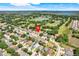 An aerial view of a neighborhood with homes surrounded by lush greenery, lakes, and community amenities at 1159 Greenley Ave, Groveland, FL 34736