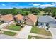 A neighborhood showcasing well-maintained homes and lush green landscaping, adjacent to a beautiful golf course at 1159 Greenley Ave, Groveland, FL 34736