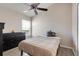 Bedroom features a ceiling fan, wood-look flooring, a window, and a dark wood dresser at 1159 Greenley Ave, Groveland, FL 34736