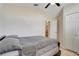 Neutral bedroom features a ceiling fan, double door closet, and an open door to the ensuite bathroom at 1159 Greenley Ave, Groveland, FL 34736