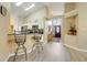 Open concept kitchen with bar stool seating flows into a foyer and the front door of the home at 1159 Greenley Ave, Groveland, FL 34736