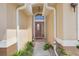 Inviting front entrance with decorative plants and a covered porch, creating a warm and welcoming first impression at 1159 Greenley Ave, Groveland, FL 34736