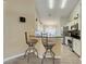 An eat-in kitchen with breakfast bar offers stainless steel appliances and a view into a dining area at 1159 Greenley Ave, Groveland, FL 34736