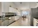 Bright kitchen with wood-look floors, granite countertops, stainless steel appliances and a casual dining area at 1159 Greenley Ave, Groveland, FL 34736