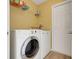 A laundry room with yellow walls is equipped with an LG front load washer and dryer at 1159 Greenley Ave, Groveland, FL 34736
