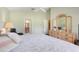 Main bedroom with comfortable bed, dresser and views into the main bathroom at 1159 Greenley Ave, Groveland, FL 34736