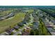 Aerial view of the community showcasing well-maintained homes, lush greenery, and a beautiful golf course at 11860 Se 179Th St, Summerfield, FL 34491