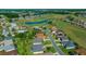 Beautiful aerial view of homes along a golf course with a large pond and lush green surroundings at 11860 Se 179Th St, Summerfield, FL 34491