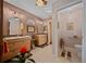 Bright bathroom featuring double vanities, tiled floors, and stylish fixtures at 11860 Se 179Th St, Summerfield, FL 34491