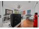 Bonus room features a music area, posters on the wall, and hardwood floors at 11860 Se 179Th St, Summerfield, FL 34491