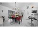 Stylish dining area featuring modern table set, unique lighting, and open flow to adjacent rooms at 11860 Se 179Th St, Summerfield, FL 34491
