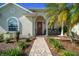 Inviting home exterior with brick walkway, front sitting porch, and lush landscaping at 11860 Se 179Th St, Summerfield, FL 34491