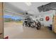 Well-organized three-car garage equipped to store a golf cart, motorcycle, and more at 11860 Se 179Th St, Summerfield, FL 34491