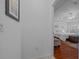 Hallway leading to main bedroom with hardwood floors and access to an ensuite bathroom at 11860 Se 179Th St, Summerfield, FL 34491