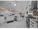 Modern kitchen features white cabinetry, granite countertops, stainless steel appliances, and pendant lighting at 11860 Se 179Th St, Summerfield, FL 34491