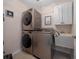 Functional laundry room with stacked washer and dryer units, plus a sink for added convenience at 11860 Se 179Th St, Summerfield, FL 34491