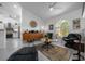 Bright living room with high ceilings, a modern entertainment center, and a cozy seating area at 11860 Se 179Th St, Summerfield, FL 34491