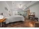 Comfortable bedroom with tray ceiling, fan, closet, wood floors, and decor at 11860 Se 179Th St, Summerfield, FL 34491