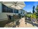 Outdoor patio area with a dining set, grill, and landscaped yard at 11860 Se 179Th St, Summerfield, FL 34491