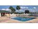 Community pool with brick surround, lounge chairs, and well-maintained landscaping at 11860 Se 179Th St, Summerfield, FL 34491