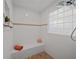 This walk-in shower has a glass block window, a built in bench, and stylish tilework at 11860 Se 179Th St, Summerfield, FL 34491