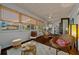 Cozy sun room with dark wood floor, ceiling fan, and wicker furniture at 11860 Se 179Th St, Summerfield, FL 34491
