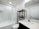 Bright bathroom features a shower with white tile, a sleek vanity, and modern fixtures for a clean, fresh look at 11995 Callicarpa Ln, Leesburg, FL 34788