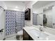 Modern bathroom features decorative shower curtain, updated vanity, and functional layout at 11995 Callicarpa Ln, Leesburg, FL 34788