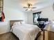 Comfortable bedroom with a ceiling fan, natural light, and workstation at 11995 Callicarpa Ln, Leesburg, FL 34788