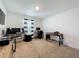 Spacious bedroom with natural light, a ceiling fan, and ample space for multiple workstations at 11995 Callicarpa Ln, Leesburg, FL 34788