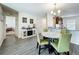 Open-concept dining area with marble-look round table and adjacent modern kitchen at 11995 Callicarpa Ln, Leesburg, FL 34788