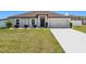 Charming single-Gathering home with a well-manicured lawn, inviting entryway, and two-car garage at 11995 Callicarpa Ln, Leesburg, FL 34788