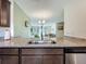Stylish kitchen overlooking the living area, with stainless steel appliances and elegant granite countertops at 11995 Callicarpa Ln, Leesburg, FL 34788