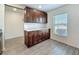Additional kitchen cabinets featuring white quartz countertops and gray wood-look floors at 11995 Callicarpa Ln, Leesburg, FL 34788