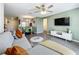Open-concept living room with modern decor features eat-in kitchen with stainless appliances and inviting living space at 11995 Callicarpa Ln, Leesburg, FL 34788