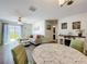 Bright and airy living room with stylish decor, ample seating, and a view of the outdoor space at 11995 Callicarpa Ln, Leesburg, FL 34788