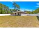 Spacious backyard with a white fence, a well-maintained lawn, and mature trees at 12150 Se 88Th Ct, Belleview, FL 34420