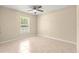 Cozy bedroom featuring a ceiling fan, tile floors and view to private fenced backyard at 12150 Se 88Th Ct, Belleview, FL 34420