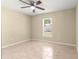 Bedroom featuring a ceiling fan, tile floors, and a bright window view at 12150 Se 88Th Ct, Belleview, FL 34420