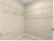 Walk-in closet with built in shelving for maximum storage and organization at 12150 Se 88Th Ct, Belleview, FL 34420