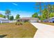 Well-maintained single-Gathering home with a spacious driveway, a two-car garage, and a manicured lawn at 12150 Se 88Th Ct, Belleview, FL 34420