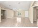Spacious living room with tile flooring, ceiling fan, and natural light at 12150 Se 88Th Ct, Belleview, FL 34420