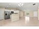 Open floor plan with kitchen, dining and living spaces with tile flooring and high ceilings at 12150 Se 88Th Ct, Belleview, FL 34420