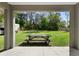 Covered back porch and lush backyard view at 12817 Sw 77Th Cir, Ocala, FL 34473