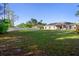 Large backyard with green grass, a picnic table, and a view of the rear exterior of the home at 12817 Sw 77Th Cir, Ocala, FL 34473
