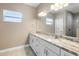 Bright bathroom featuring a double sink vanity with stone countertop and tiled floors at 12817 Sw 77Th Cir, Ocala, FL 34473