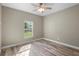 A bedroom with neutral walls, a ceiling fan, and a window offering natural light at 12817 Sw 77Th Cir, Ocala, FL 34473