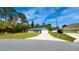 Charming single-story home boasts a well-manicured lawn, long driveway, and solar panels on the roof at 12817 Sw 77Th Cir, Ocala, FL 34473