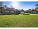 Well-manicured lawn with a home featuring solar panels and an attached two-car garage at 12817 Sw 77Th Cir, Ocala, FL 34473